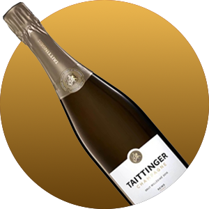 Diagonal bottle of Taittinger Champagne with a gold label, angled against a red-to-gold circular gradient background.