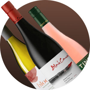 Three wine bottles tilted diagonally, showing red, white, and rosé varieties with visible labels on a brown gradient background.