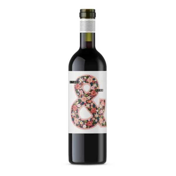 Red wine bottle with a white label featuring a large colorful floral ampersand.