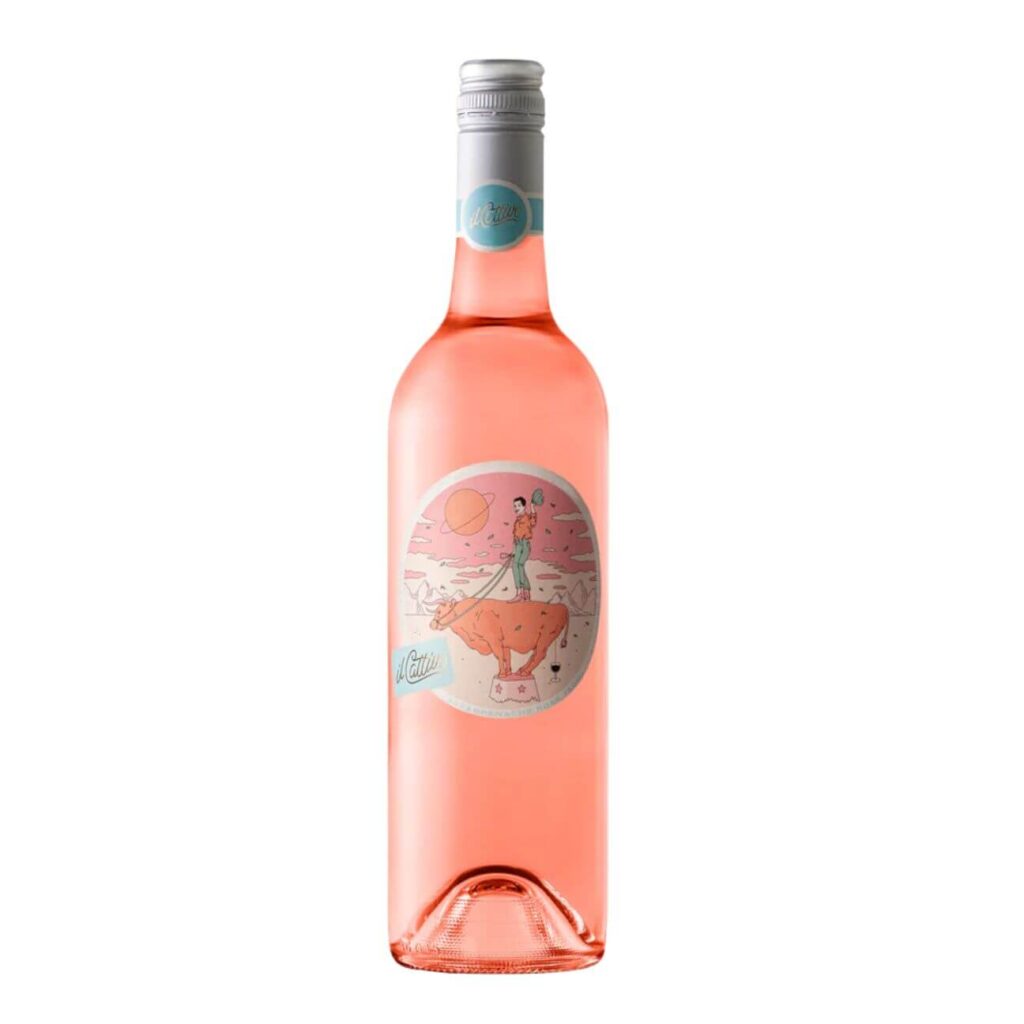 Pink sparkling beverage bottle with a vintage-style circular label featuring a person standing on an animal under a pink sky, against a white background.
