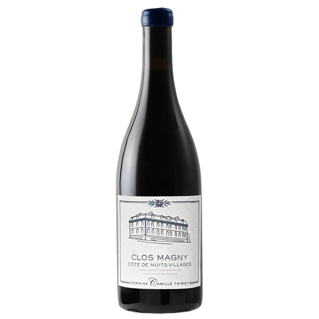 Dark wine bottle with blue foil cap and a white label reading Clos Magnny Côte de Nuits-Villages from Domaine Camille Thiriet