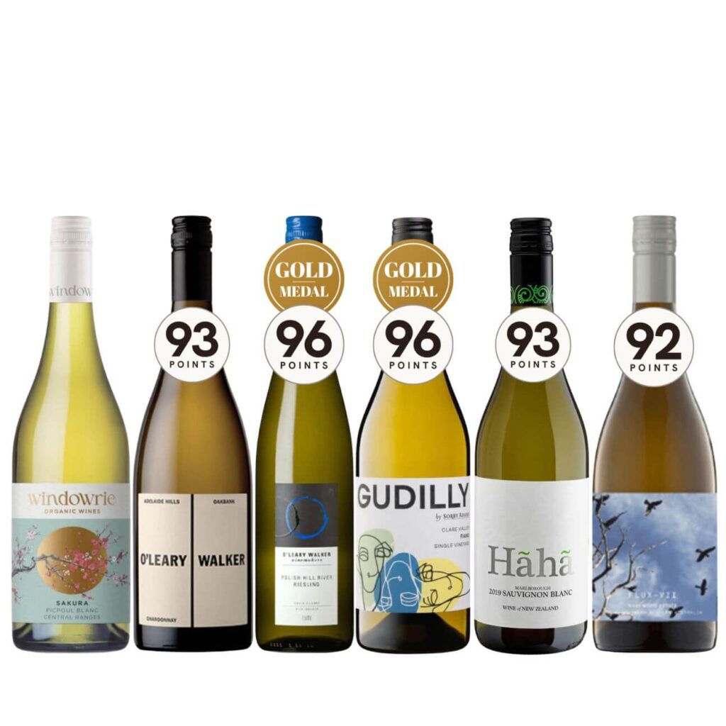 Row of six wine bottles with score badges (93, 96, 96, 93, 92) and gold medal stickers on the necks, from left to right.